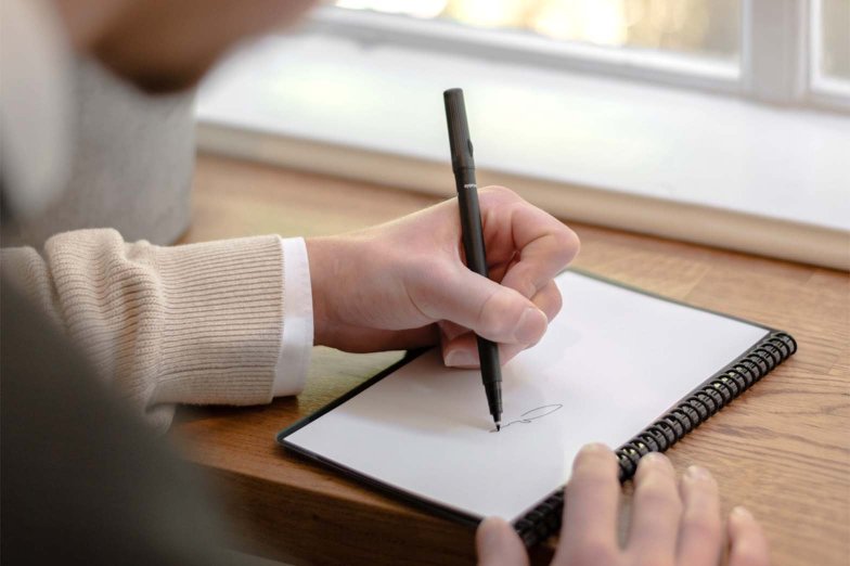 Lefthanded person writing in his Bambook notebook